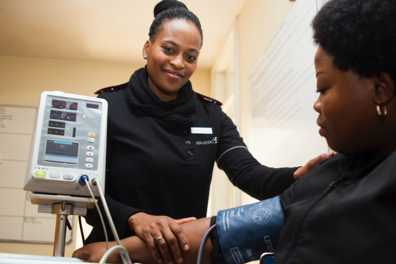 Nurse taking blood pressure of a patient
