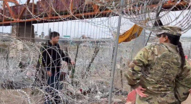 Migrant stopped by razor wire in Eagle Park, Texas.