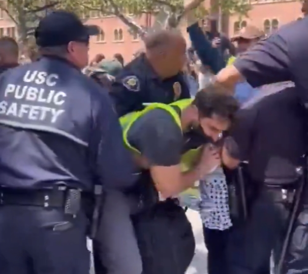 USC student protester is taken down at protests on April 26, 2024.